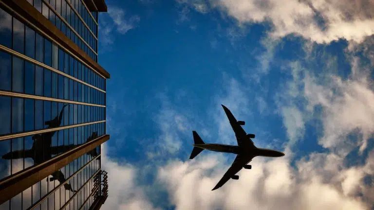 plane-blue-sky-building