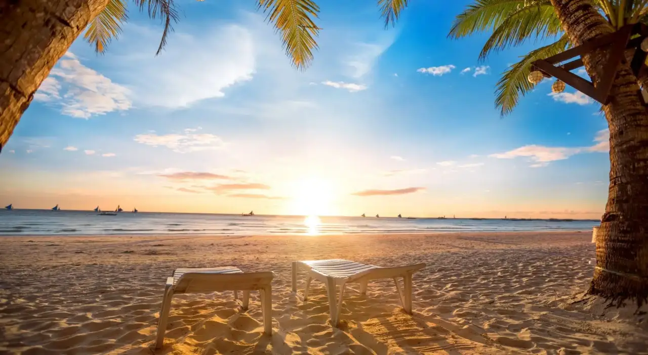 vacation scene of empty lounge chairs on a beach