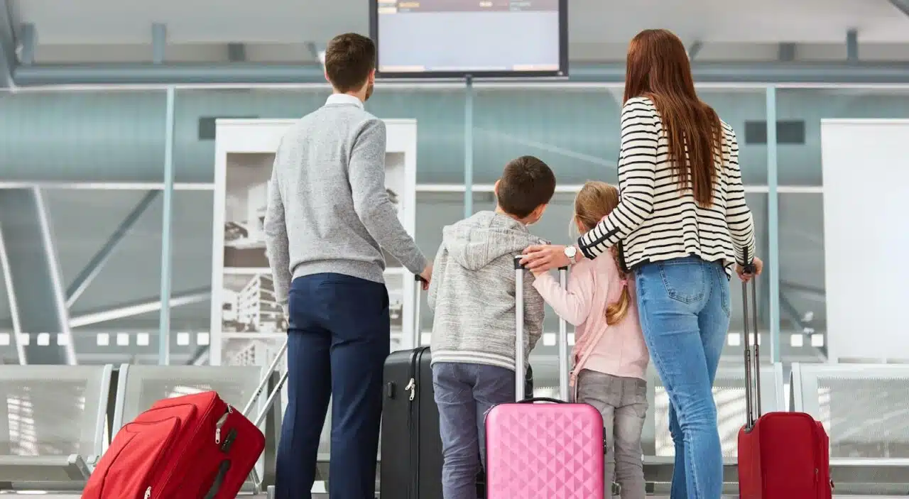 Family in terminal at preclearance airport looking for their flight