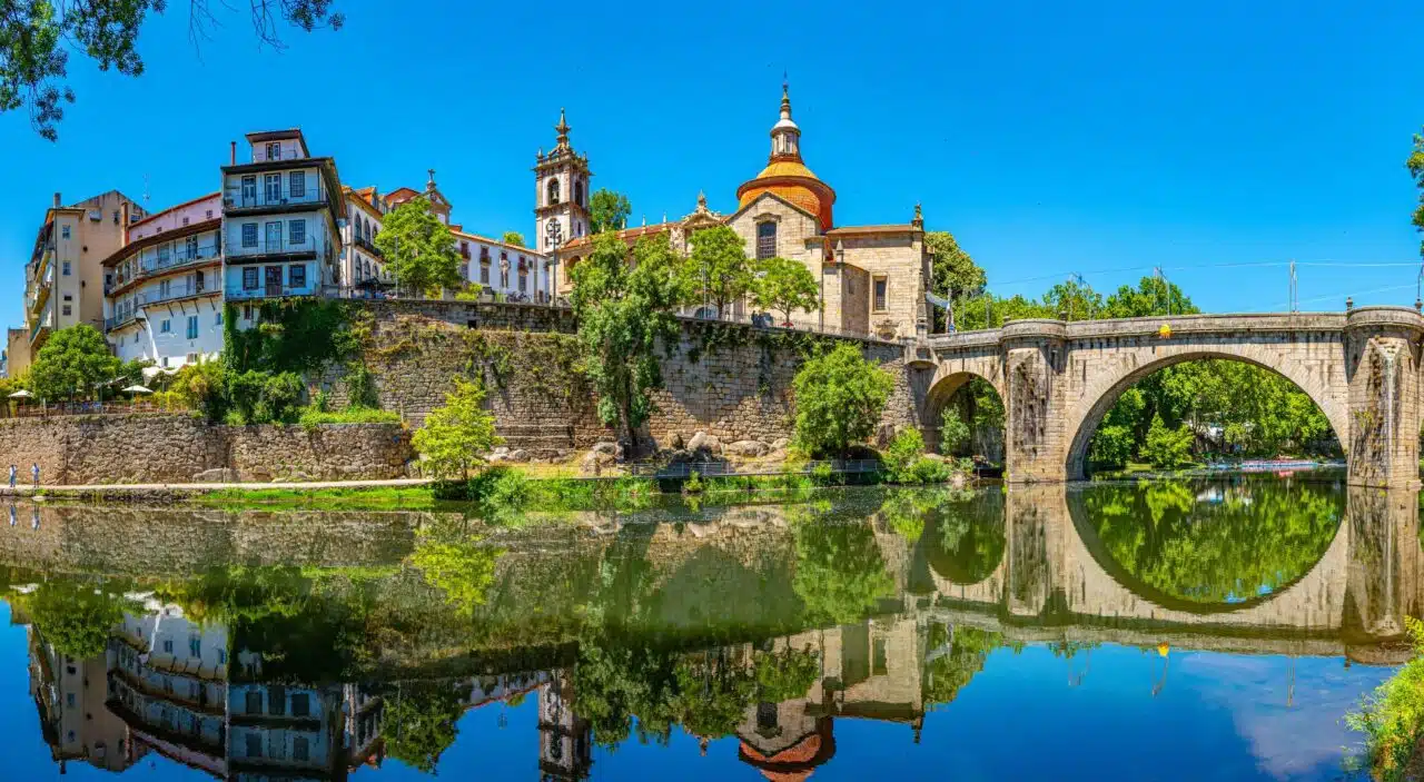 View of São Gonçalo Bridge and city with reflection in the water